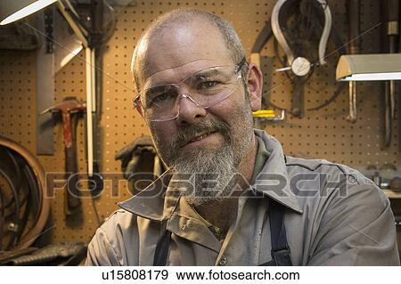 Stock Photo - Portrait of jeweler in workshop. Fotosearch