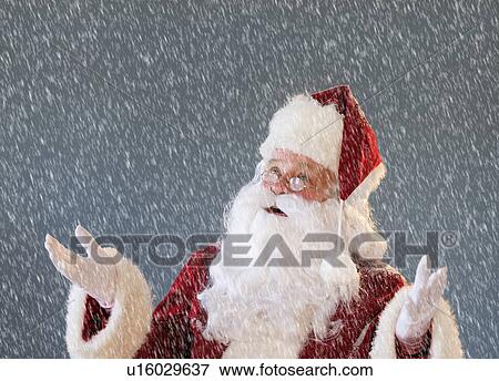 Stock Photo - Portrait of Santa Claus looking up and gesturing. Fotosearch