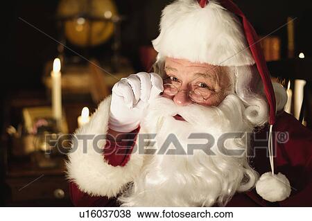 Stock Photo - Portrait of Santa Claus wearing eyeglasses. Fotosearch