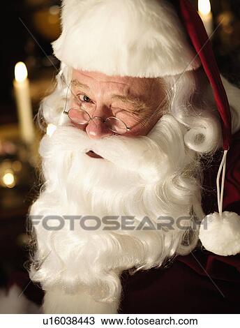 Stock Image - Portrait of Santa Claus winking. Fotosearch