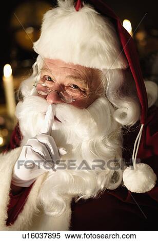 Stock Photography - Portrait of Santa Claus with finger on lips. Fotosearch