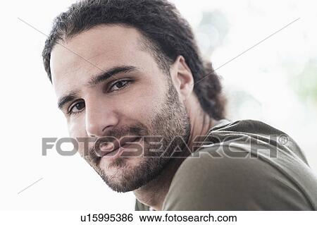 Portrait of young man with long curly hair View Large Photo Image Stock Photograph - Portrait of young man with long curly hair. Fotosearch