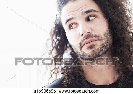 Portrait of young man with long curly hair View Large Photo Image Stock Photography - Portrait of young man with long curly hair. Fotosearch