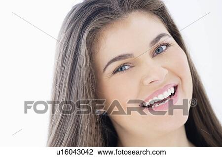 Stock Image - Portrait of young woman with brown hair. Fotosearch