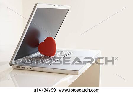 Stock Photo - Red heart on laptop computer. Fotosearch
