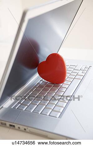 Stock Photograph - Red heart on laptop computer. Fotosearch