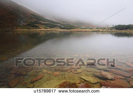 Rocks in clear water View Large Photo Image Stock Photo - Rocks in clear water. Fotosearch