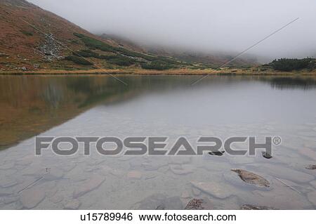 Stock Photograph - Rocks in clear water. Fotosearch