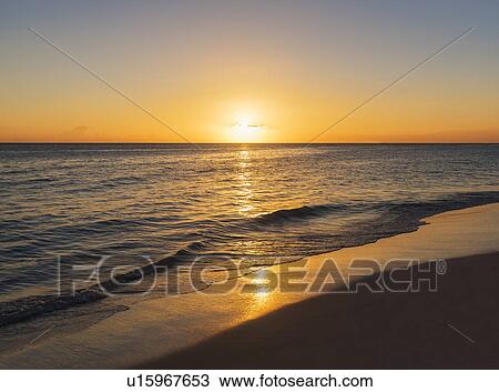 Stock Image - Romantic sunset over sea. Fotosearch