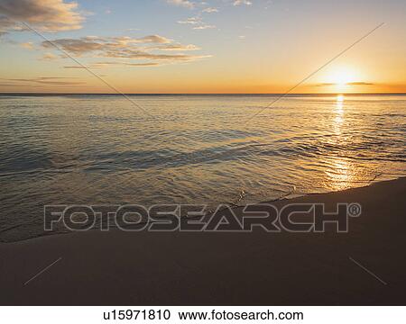 Stock Image - Romantic sunset over sea. Fotosearch