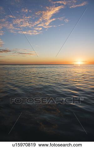 Stock Photo - Romantic sunset over sea. Fotosearch