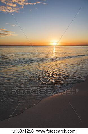 Stock Photo - Romantic sunset over sea. Fotosearch