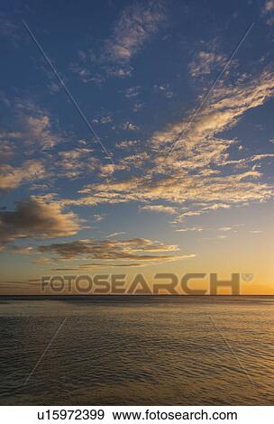 Stock Photo - Romantic sunset over sea. Fotosearch