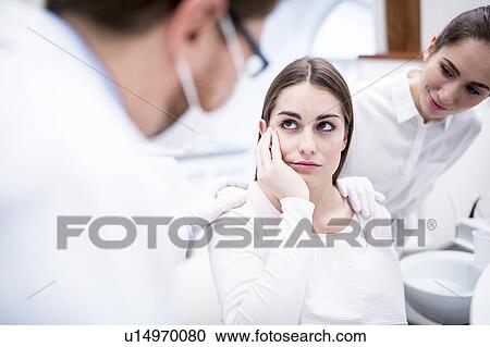 Stock Image - Sad patient in clinic. Fotosearch