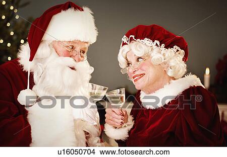 Picture - Santa and Mrs. Claus drinking champagne. Fotosearch