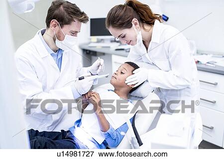 Scared boy looking at dental drill View Large Photo Image Stock Photo - Scared boy looking at dental drill. Fotosearch