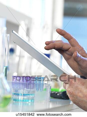 Scientist using a digital tablet View Large Photo Image Stock Image - Scientist using a digital tablet. Fotosearch