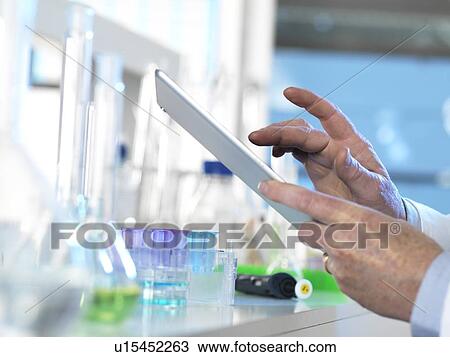 Stock Image - Scientist using a digital tablet. Fotosearch