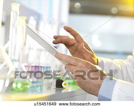 Stock Photo - Scientist using a digital tablet. Fotosearch