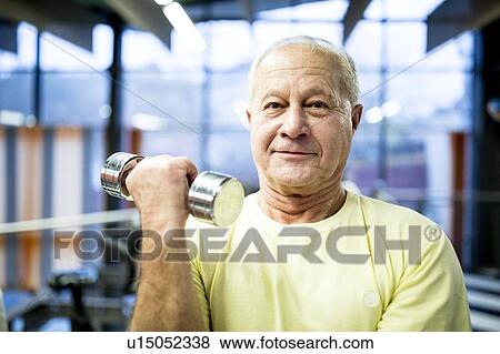 Senior man holding dumbbell View Large Photo Image Stock Photo - Senior man holding dumbbell. Fotosearch
