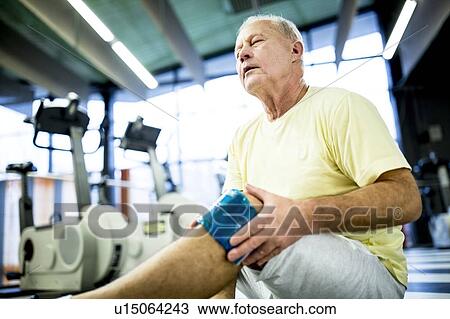 Senior man holding ice pack on knee View Large Photo Image Stock Image - Senior man holding ice pack on knee. Fotosearch