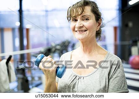 Senior woman holding dumbbell View Large Photo Image Picture - Senior woman holding dumbbell. Fotosearch
