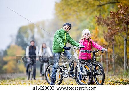 Sibling cycling together View Large Photo Image Stock Image - Sibling cycling together. Fotosearch