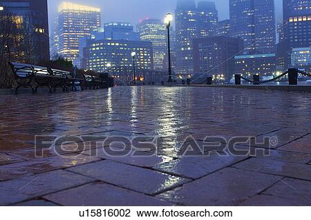 Stock Image - Sidewalk on rainy evening. Fotosearch