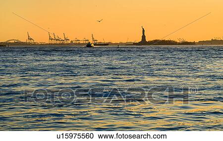 Silhouette of Statue of Liberty at sunset View Large Photo Image Stock Image - Silhouette of Statue of Liberty at sunset. Fotosearch