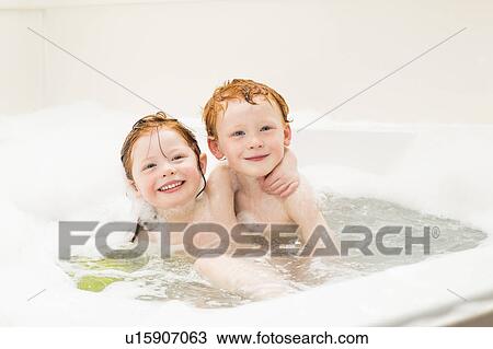 Stock Image - Sister and brother (2-3, 4-5) having bubble bath. Fotosearch