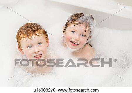 Stock Image - Sister and brother (2-3, 4-5) having bubble bath. Fotosearch
