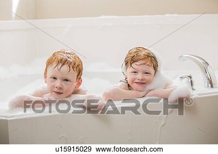 Stock Photo - Sister and brother (2-3, 4-5) having bubble bath. Fotosearch