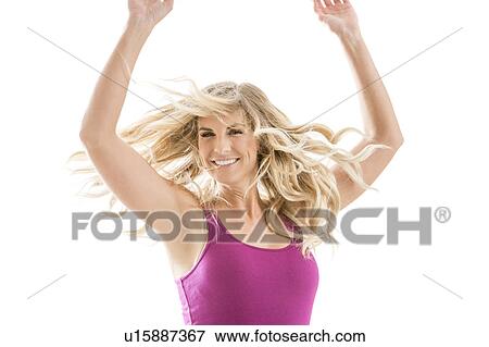 Stock Photo - Smiling blonde woman dancing. Fotosearch