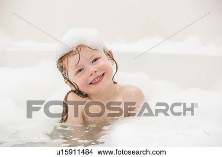 Picture - Smiling girl (4-5) having bubble bath. Fotosearch