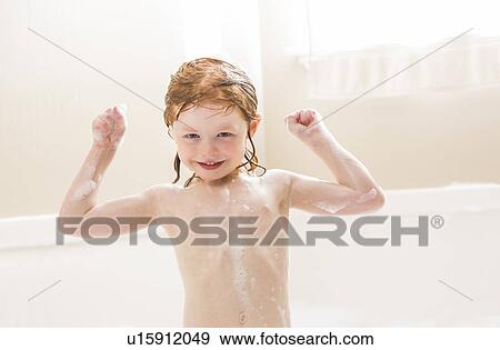 Smiling girl (4-5) having bubble bath View Large Photo Image Stock Photo - Smiling girl (4-5) having bubble bath. Fotosearch