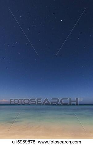 Stock Photo - Stars on blue sky over sea. Fotosearch