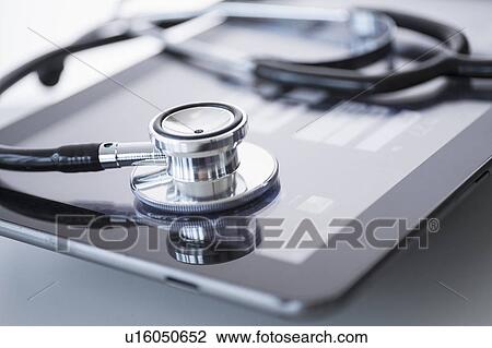 Stock Image - Stethoscope lying on digital tablet. Fotosearch