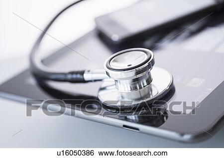 Stock Photograph - Stethoscope lying on digital tablet. Fotosearch