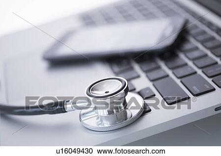 Stethoscope lying on laptop View Large Photo Image Stock Image - Stethoscope lying on laptop. Fotosearch