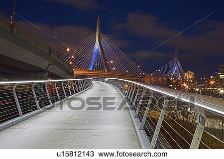 Stock Image - Suspension bridge at dusk. Fotosearch