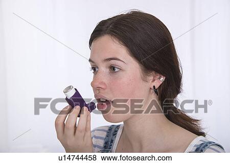 Teenage girl using asthma inhaler View Large Photo Image Stock Photo - Teenage girl using asthma inhaler. Fotosearch