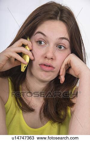 Stock Image - Teenage girl using mobile phone. Fotosearch
