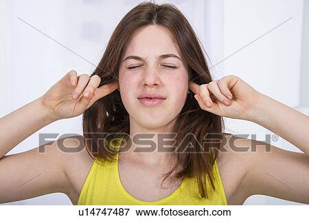 Teenage girl with fingers in ears View Large Photo Image Stock Photo - Teenage girl with fingers in ears. Fotosearch