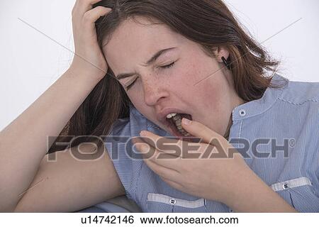 Stock Photograph - Teenage girl yawning. Fotosearch