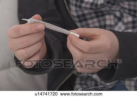 Teenager with a marijuana cigarette View Large Photo Image Stock Image - Teenager with a marijuana cigarette. Fotosearch