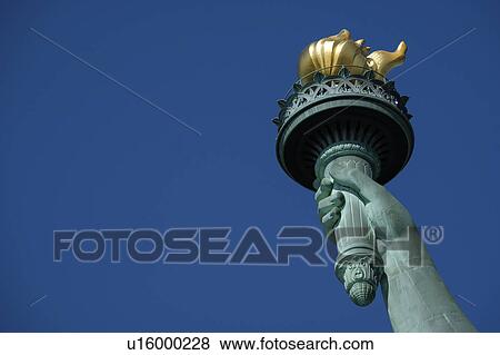 Stock Photo - Torch of Statue of Liberty against clear sky. Fotosearch