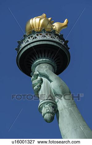 Stock Photo - Torch of Statue of Liberty against clear sky. Fotosearch