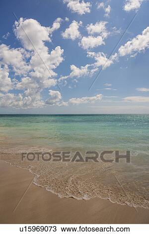 Stock Image - White clouds over tropical sea. Fotosearch