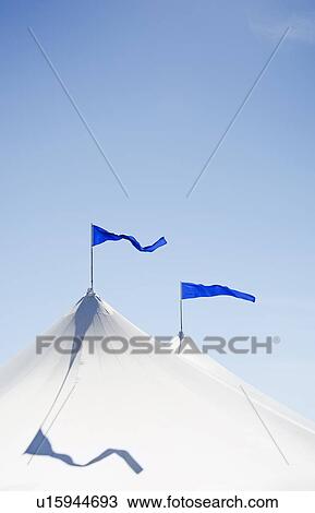 White tents with blue flags at county fair View Large Photo Image Stock Image - White tents with blue flags at county fair. Fotosearch