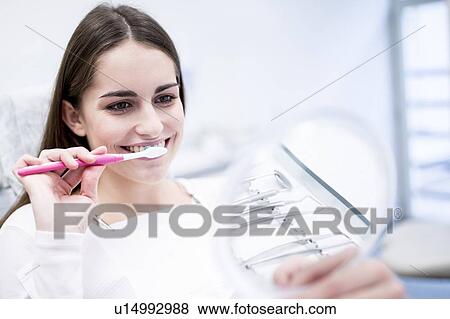Woman brushing teeth View Large Photo Image Stock Photo - Woman brushing teeth. Fotosearch